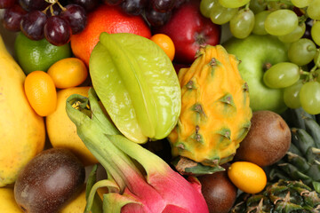 Fototapeta na wymiar Assortment of fresh exotic fruits as background, top view