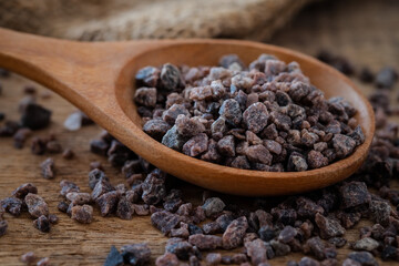 Himalayan black rock salt on wooden spoon