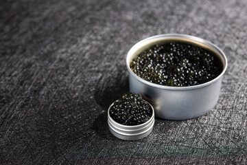 Fototapeta na wymiar Fish black caviar on a dark stone