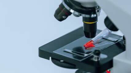 microscope on the table in the laboratory for research of a new virus .