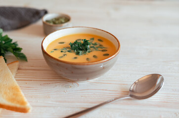 Homemade pumpkin soup in the grey ceramic bowl. Healthy vegetables vegeterian launch food