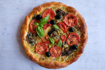 Traditional Italian dish-pizza. Vegetarian homemade pizza on a light background. The concept of healthy eating..