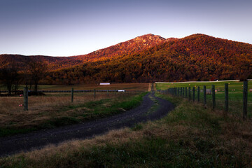 Dawn at Old Rag Mountain in Shenandoah National Park as the red morning light lights up the autumn...
