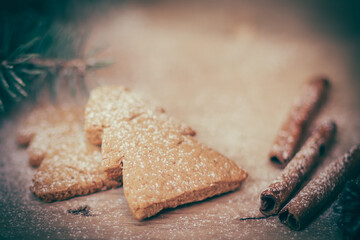 cinnamon sticks, cookies and Christmas tree branch but the table