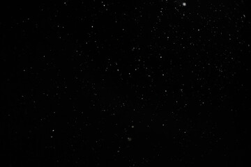 Snow against a black sky. Snow on a black background. Snow background.