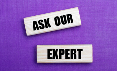 On a lilac bright background, light wooden blocks with the text ASK OUR EXPERT