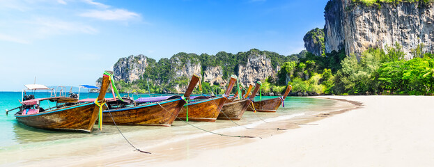 Thai traditional wooden longtail boat and beautiful sand beach. - obrazy, fototapety, plakaty
