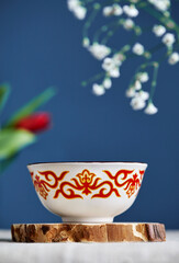 Kazakh tea bowl kese with tea and flowers on Nauryz festival