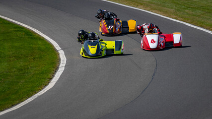 A shot of a racing sidecar as it corners on a track.