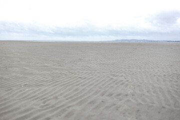 Sand beach with the coast of Dublin, Ireland.