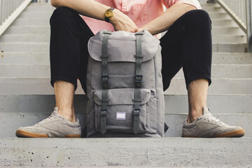 Fototapeta A man sitting with a backpack obraz