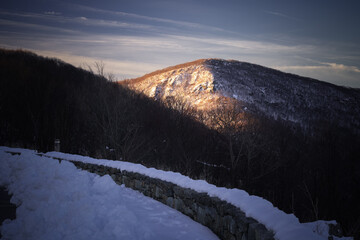 Hawksbill Mountain, the tallest peak in Shenandoah National Park, catches morning sunlight on a...