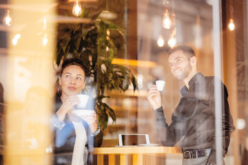 Business coleagues having a coffee at a cafe bar