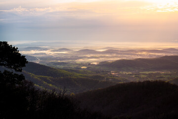 A wide view of the morning glow down into the farmlands of the Virginian piedmont around Shenandoah National Park.