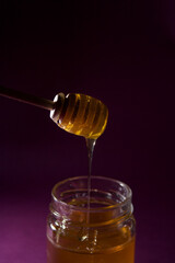 Fototapeta na wymiar honey dripping from a glass jar