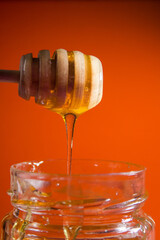 Fototapeta na wymiar honey dripping from a jar