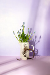 Sunny Easter composition, front view of spring flowers, and white porcelain bunny