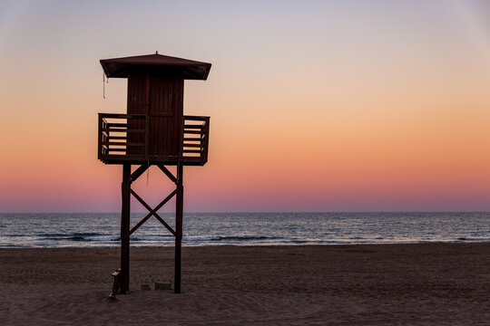 wooden  Lifeguard Tower at the beach with sunset lightning