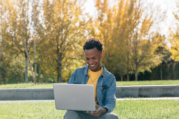 Afro boy smiles while making video call in a park