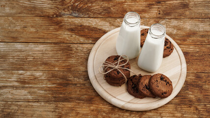 Homemade Chocolate Chip Cookies and Milk on wooden background in rustic style