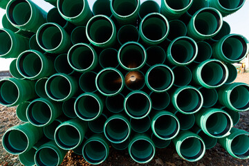Viele grüne Rohre gestapelt auf einer Baustell