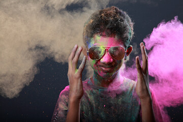Boy plays with Holi festival colours.Concept for Indian festival Holi.