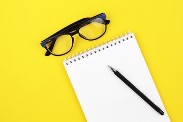 pen and glasses with notebook 