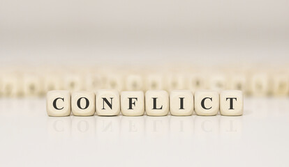 Word CONFLICT made with wood building blocks