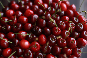 Lots of red cherry berries in a berry-based bouquet in daylight. Smooth, round delicious bouquet. Rasfokus, fudfloristika, floristika. High quality photo
