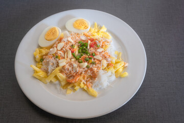 Thai rice noodles with pineapple and coconut milk the delicious of traditional food served on white plate in Thai name is Kanom Cheen Saw Num.