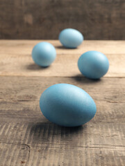 Naturally colored organic eggs on a rustic table