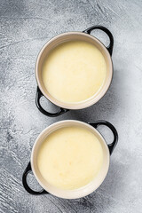 Homemade potato cream soup in bowls. White background. Top view
