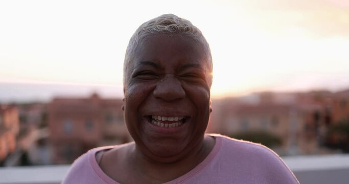 Happy latin mature woman looking and smiling in camera