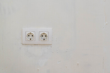 old outlet on the white wall background