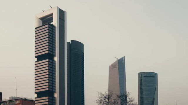 Modern skyscrapers architecture view. Four Towers Business Area during evening against grey sky. Business district located in Paseo de la Castellana in Madrid, Europe, Spain