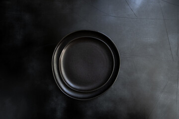 Food cooking background. Empty  craft plate on dark  table. Top view, copy space, Table setting. background for menu, layout, place for text