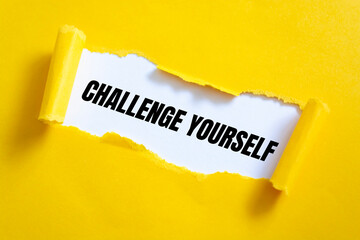 CHALLENGE YOURSELF message written under torn paper.