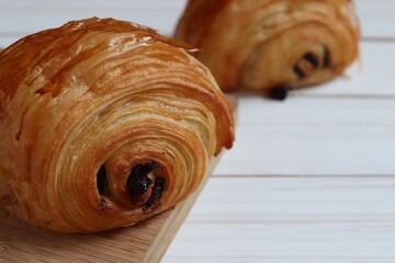 Chocolate croissant on  wooden background