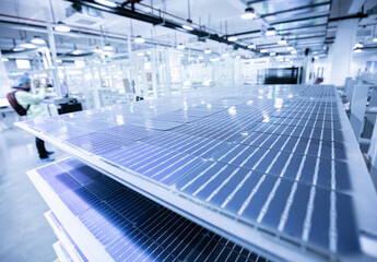 Solar panel manufacturing workshop, workers operate modern CNC machine tools. 4.0 in industry. Smart factory.