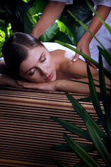 portrait of young beautiful woman in spa environment - 419401136