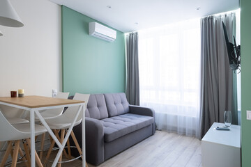 Modern interior. Scandinavian style dining table and sofa