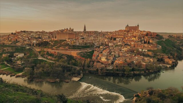Time-lapse above aerial drone point of view Toledo historical picturesque city of Spain surrounded by Tagus river located on hilltop, day evening scene view. Castilla&ndash;La Mancha. Timelapse hyper lapse 