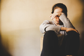 A woman sitting alone and depressed.