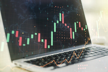 Abstract creative financial graph with world map on modern computer background, financial and trading concept. Multiexposure