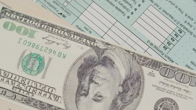 Stimulus economic tax return check and and 1040 Form with dollars.