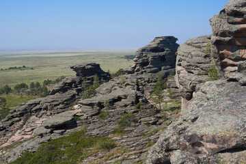 The top of a mountain range against the background of fields and forests