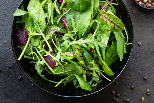 green mix salad lettuce, Swiss chard, leaves, arugula, spinach, iceberg, Romano salad snack healthy meal top view copy space food background rustic image keto or paleo diet vegan or vegetarian