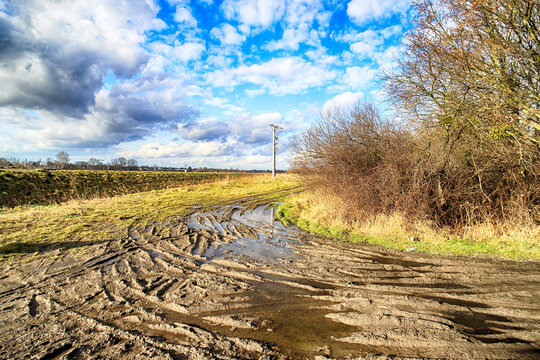 WROCLAW, POLAND - FEBRUARY 19, 2021: Mud in the field on a sunny day. The vicinity of the Channel between the Oder River and the Widawa River during the thaw.  Wroclaw, Poland, Europe.