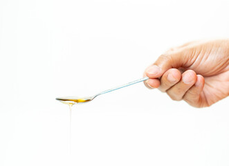 Golden Honey dripping from spoonful.