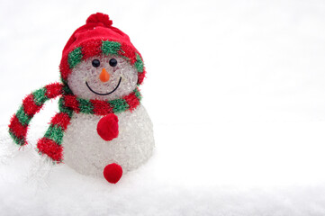 cute snowman ornament on white snow background and copy space